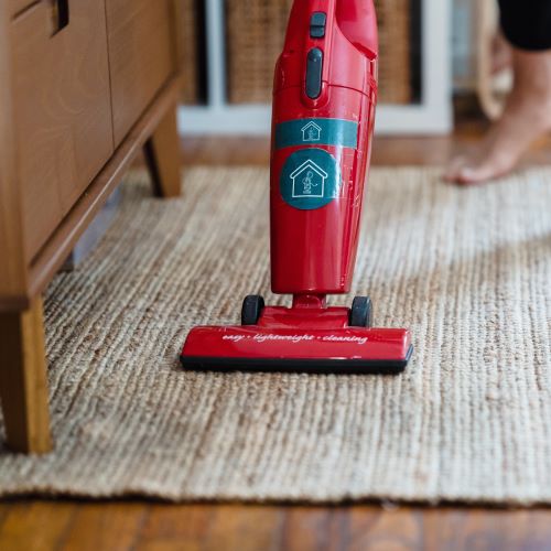 Person vacuuming a rug