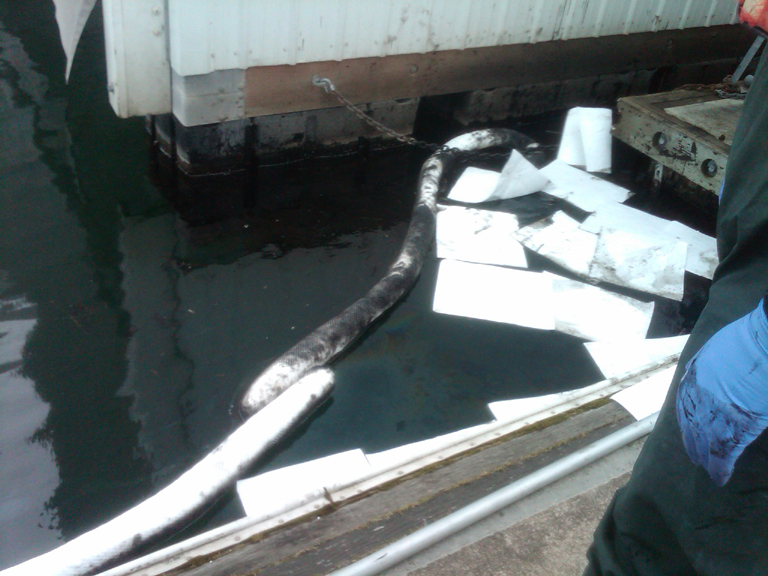Absorbent pads and boom used to cleanup spill in Squalicum Marina.